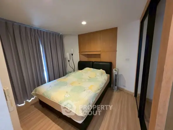 Cozy bedroom with modern decor and ample natural light