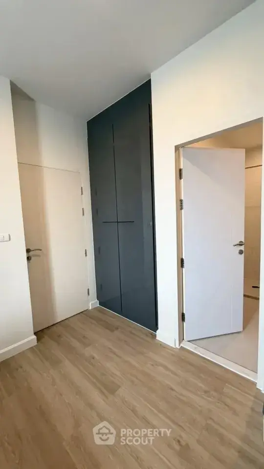Modern minimalist interior with sleek wooden flooring and stylish doors