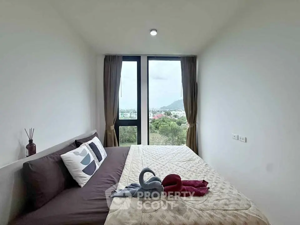 Cozy bedroom with scenic window view and elegant decor
