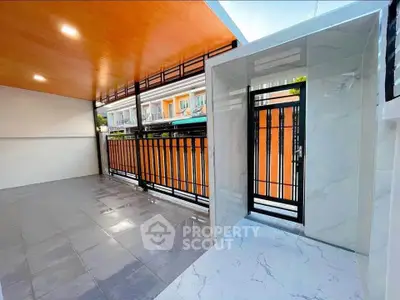 Spacious balcony with modern design and elegant railing in a vibrant neighborhood.