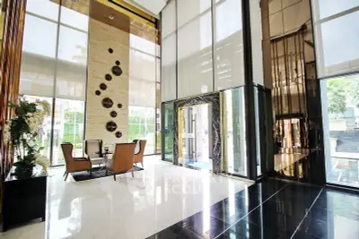 Luxurious modern building entrance with high ceilings and elegant decor