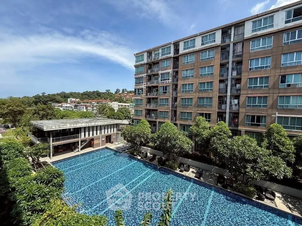 Luxurious apartment complex with stunning pool and lush greenery