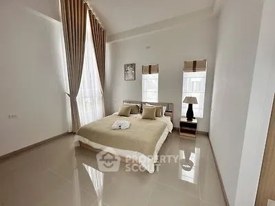 Spacious modern bedroom with high ceilings and elegant decor