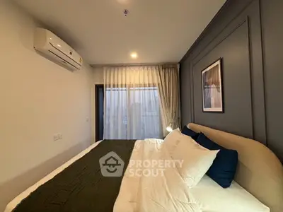 Modern bedroom with stylish decor and large window for natural light.