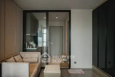 Modern living room with glass partition and cozy sofa in stylish apartment