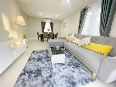 Spacious modern living room with elegant decor and cozy seating area.