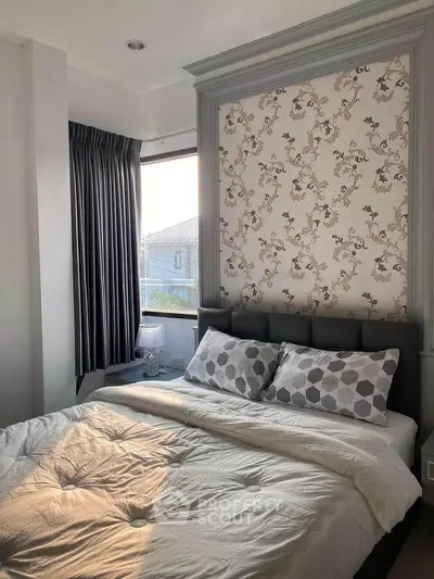 Cozy bedroom with elegant wallpaper and natural light