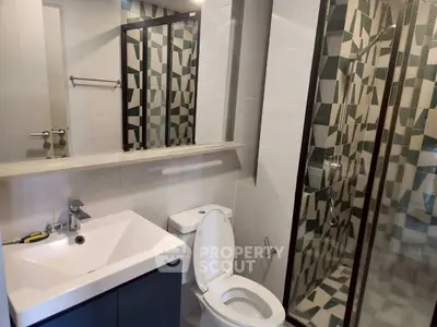 Modern bathroom with geometric tile shower and sleek fixtures
