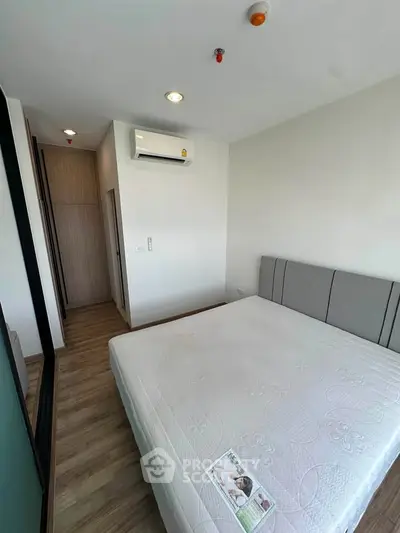Modern bedroom with air conditioning and stylish decor in a cozy apartment.