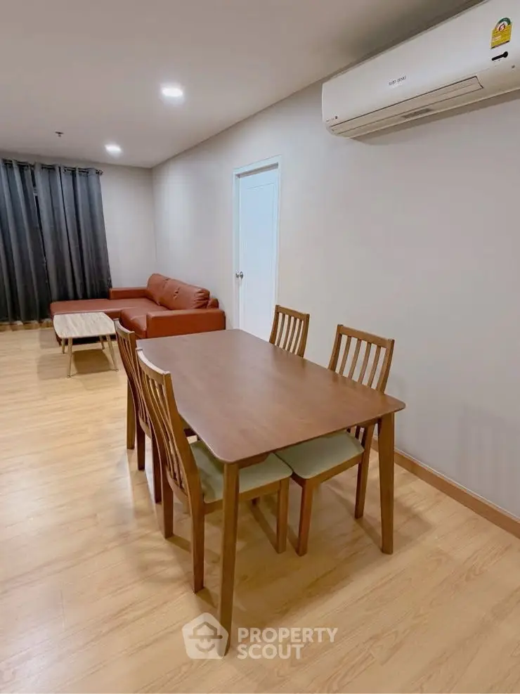 Spacious living room with modern furniture and air conditioning