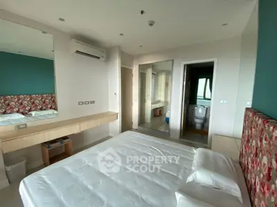 Modern bedroom with ensuite bathroom and stylish decor in a contemporary apartment.