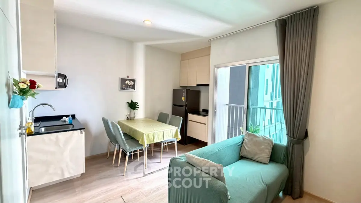 Modern living room with open kitchen and balcony in a stylish apartment