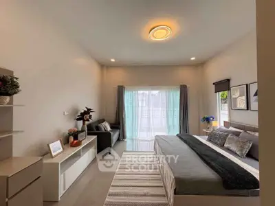 Spacious modern bedroom with stylish decor and natural light