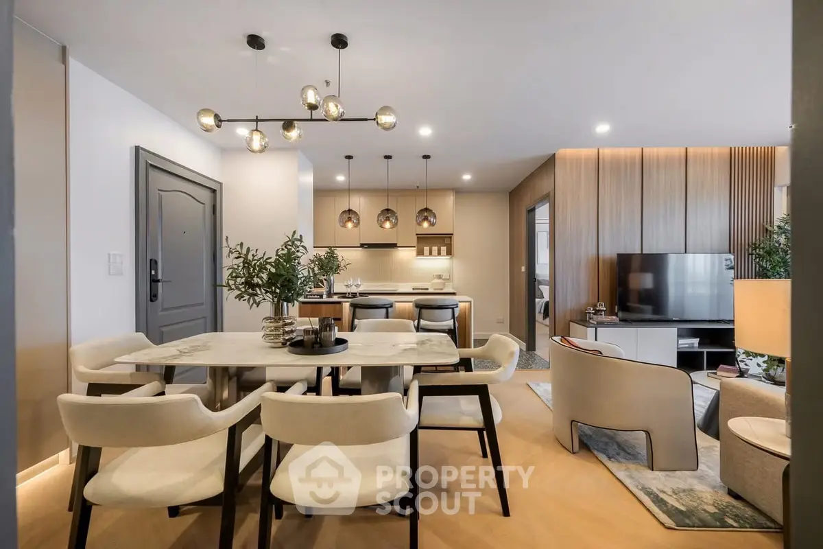 Luxurious open-plan living and dining area with modern decor and elegant lighting.