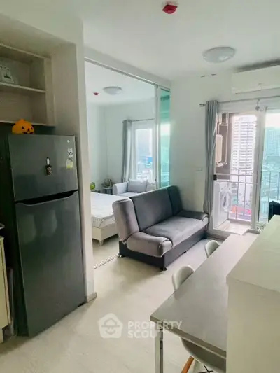 Modern apartment interior with open layout, featuring kitchen, living area, and balcony with city view.