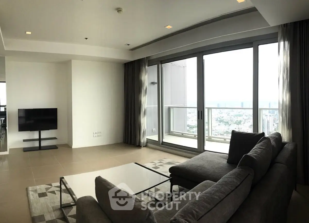 Spacious modern living room with large windows and stunning city view