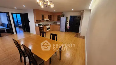 Spacious open-layout kitchen and dining area with modern appliances and wooden flooring.