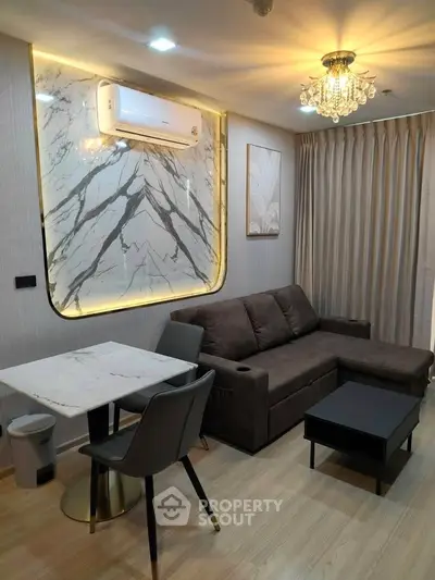 Modern living room with elegant marble accent wall and stylish furniture