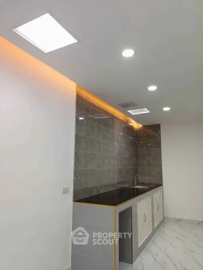 Modern kitchen with sleek marble backsplash and recessed lighting