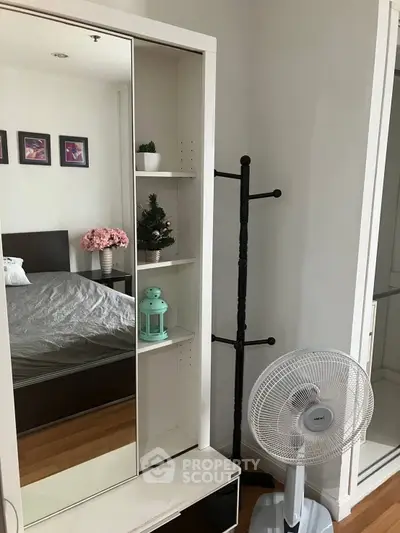 Cozy bedroom with mirrored wardrobe and stylish decor