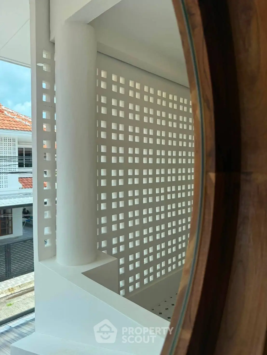 Modern architectural design with unique lattice wall and circular window, offering a stylish and airy ambiance.