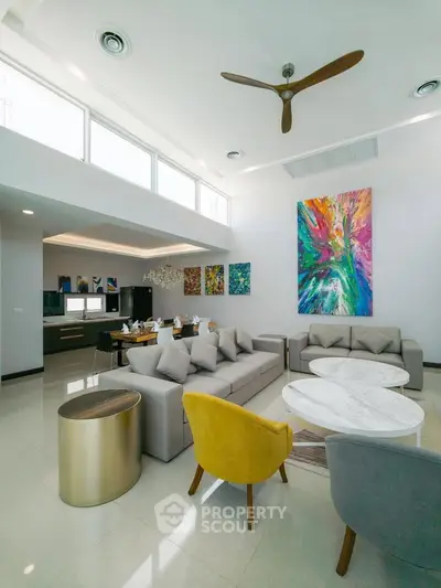 Luxurious modern living room with high ceilings and vibrant artwork