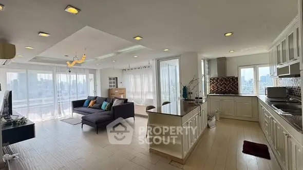 Spacious open-plan living room and kitchen with modern design and city view.