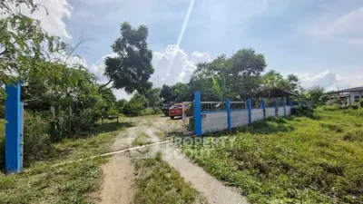 Spacious rural property with lush greenery and gated entrance, perfect for development or farming.