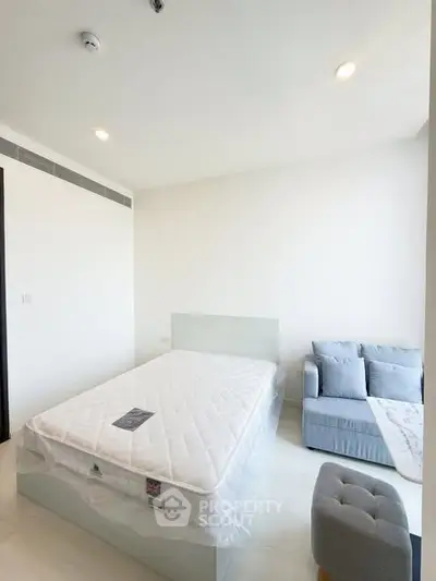 Bright and airy bedroom with modern furnishings and ample natural light.