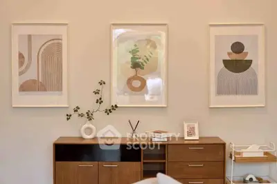 Stylish modern living room with abstract art and elegant wooden furniture.