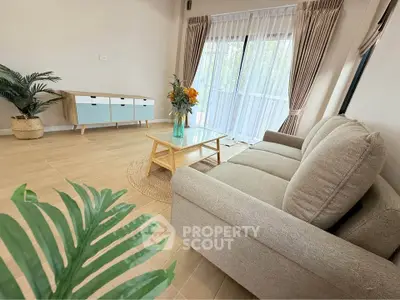 Spacious living room with modern decor and large windows for natural light.