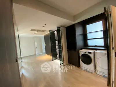 Spacious laundry area with modern washer and dryer in sleek interior design.