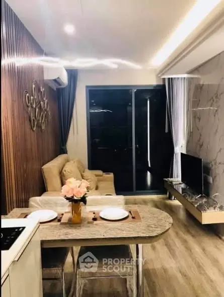 Modern living room with elegant decor and open layout, featuring a cozy seating area and stylish dining space.