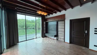 Spacious living room with stunning river view and wooden ceiling beams