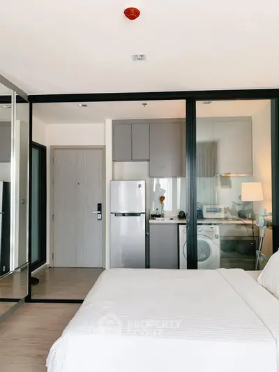 Modern studio apartment with sleek kitchen and cozy bedroom