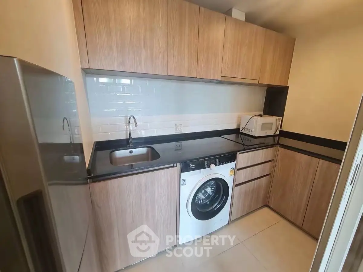 Modern kitchen with wooden cabinets and built-in appliances