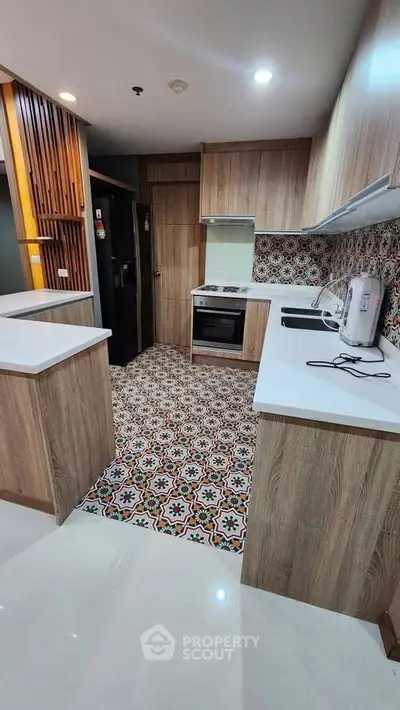 Modern kitchen with stylish patterned tiles and wooden cabinetry
