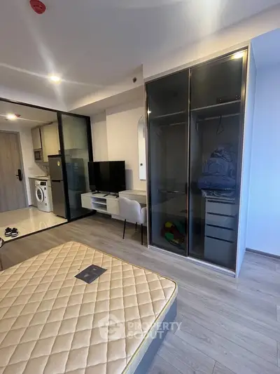Modern studio apartment with sleek design and built-in wardrobe