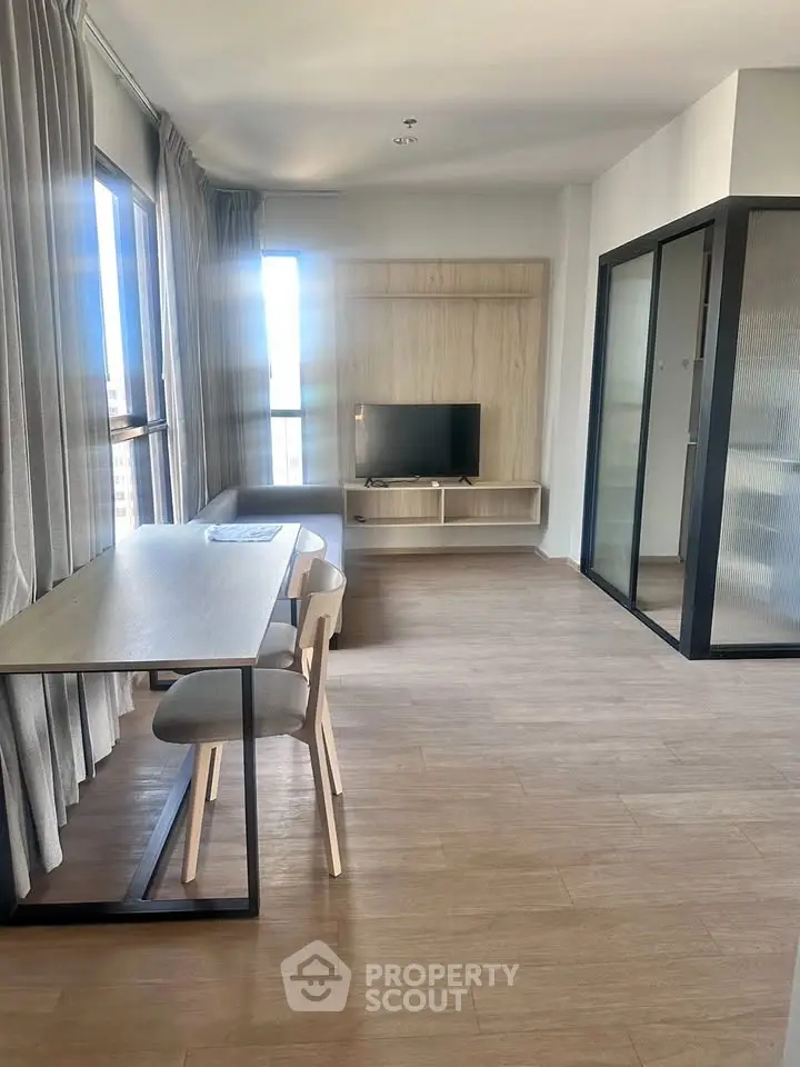 Modern living room with sleek furniture and natural light, perfect for urban living.