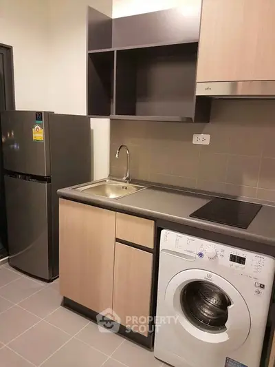 Modern kitchen with sleek appliances and efficient layout in a stylish apartment.