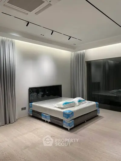 Modern bedroom with sleek design and large windows