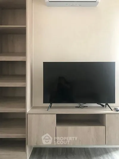 Modern living room with sleek TV unit and built-in shelves