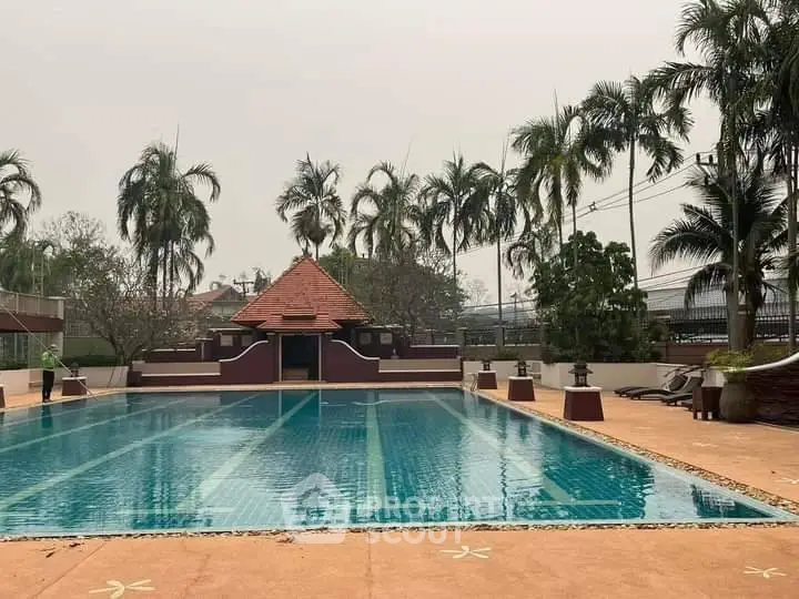 Luxurious outdoor pool with tropical palm trees and serene ambiance