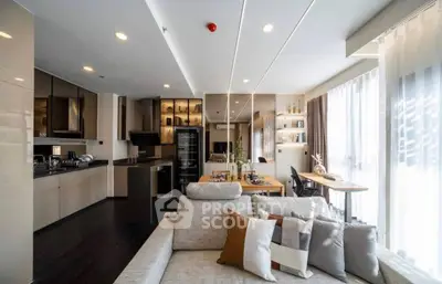 Spacious modern living room with open kitchen and elegant decor, featuring large windows and stylish furniture.