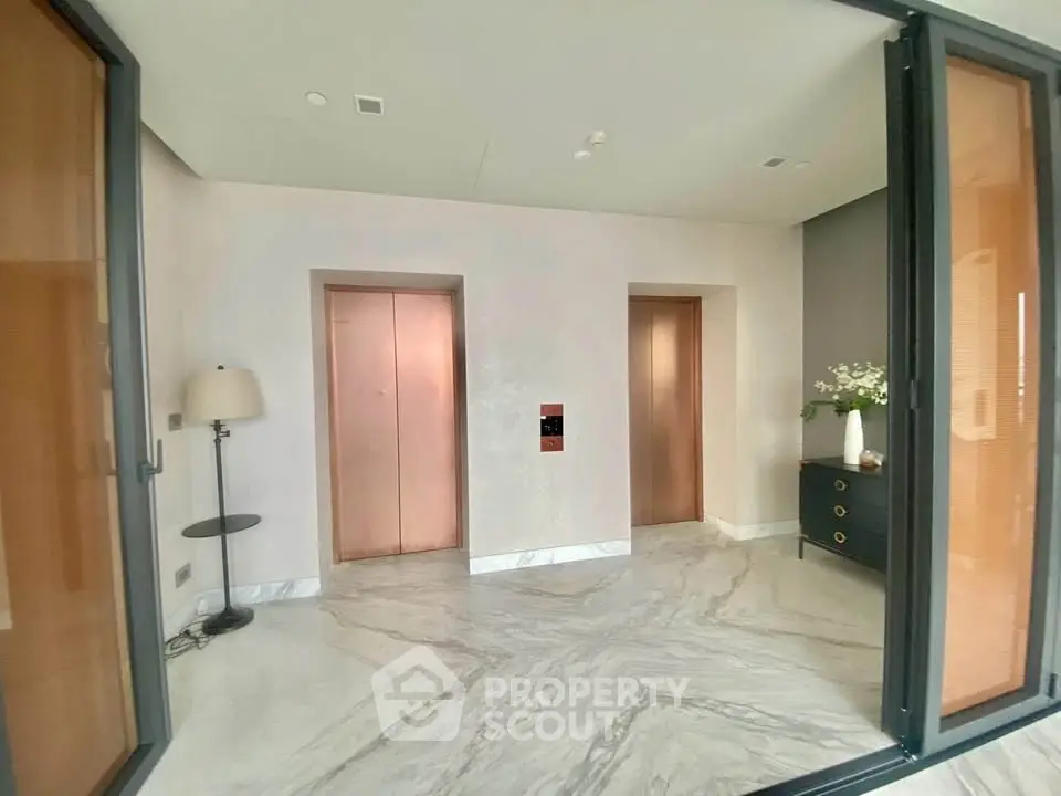 Elegant building lobby with marble flooring and modern elevators