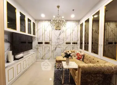 Luxurious living room with elegant chandelier and plush seating in a modern apartment.