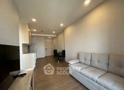 Spacious modern living room with cozy sofa and dining area in open layout apartment.