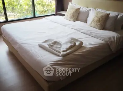 Luxurious bedroom with elegant decor and large window view, perfect for relaxation and comfort.