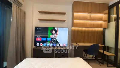 Modern bedroom with stylish wooden furniture and large TV, perfect for relaxation and entertainment.