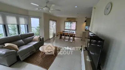 Spacious living room with modern furniture and large windows for natural light.